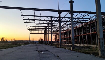 Fototapeta premium Expansive Derelict Warehouse with Pallet Racking at Dawn Light