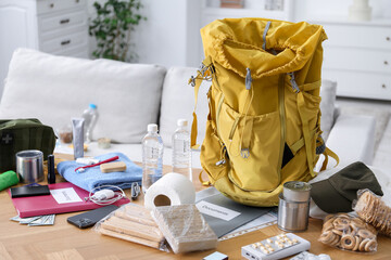 Survival kit. Different emergency supplies on wooden table indoors