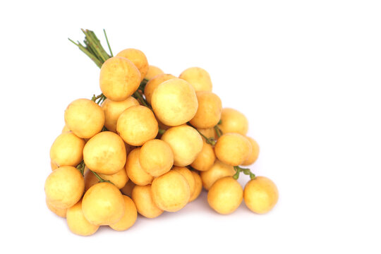 Bunch of ripe yellow Baccaurea ramiflora Lour, locally known as Mafai in Thai, beautifully isolated on a clean white background. Concept: tropical fruits with a sweet and slightly sour taste.   