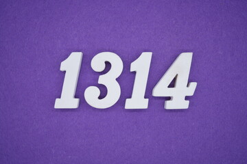 The numbers are made of white painted wood placed on a purple paper background.