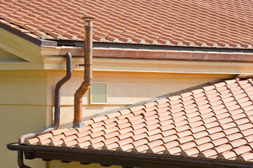 Metal chimney with copper pipe on rooftop - Exhaust pipe on the roof of the condensing boilers