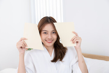 young, woman, beauty, skincare, reveal: Asian female in spa robe tears blank paper apart to...