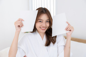 young, woman, beauty, skincare, reveal: Asian female in spa robe tears blank paper apart to...