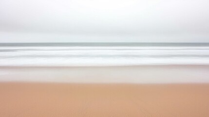 A serene coastal landscape with soft, blurred waves.