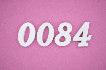 The numbers are made of white painted wood, placed on a pink paper background.