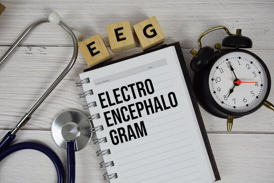 EEG - Electroencephalogram acronym on notepad, Healthcar and Medical concept background - Powered by Adobe