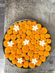 A large brass bowl filled with marigold flowers in Jaipur, India