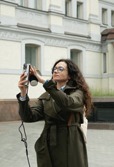 Stylish woman walking city streets with coffee