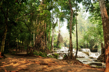 Tat Kuang Si Waterfalls or Kuang Xi Falls for Laotian people and foreign travelers travel visit and play swimming shallow water pools atop a steep hillside in nation park at Luang Prabang, Laos