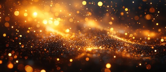 Fototapeta premium Glittering gold dust, dark background, bokeh