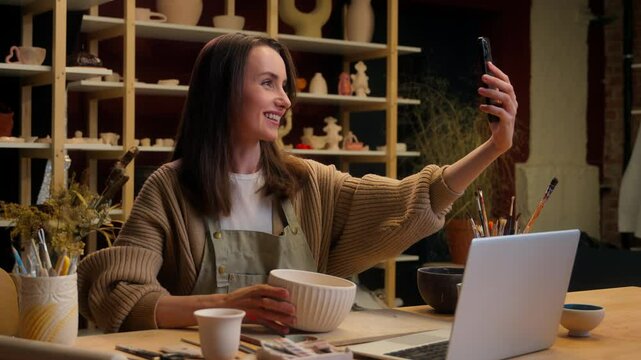 Artist woman creator sculptor art designer potter small business owner saleswoman Caucasian girl blogger influencer social media phone blog video sale crockery handmade craft store pottery workshop