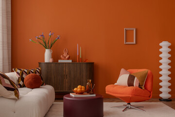 Stylish interior with geometric cushions, orange armchair, and sculptural decor. A bold, retro-inspired setting with warm hues and modern touches.