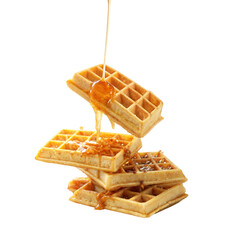 Syrup is flowing onto a stack of golden waffles isolated on transparent background