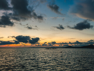 Evening clouds over sea at peaceful coastal deck