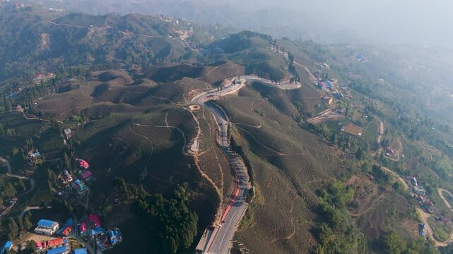 Aerial view of a green tea garden in ilam, Nepal. Fresh Green tea Field. Green tea plantation and forest nature landscape. Beautiful mountain tea garden landscape.
