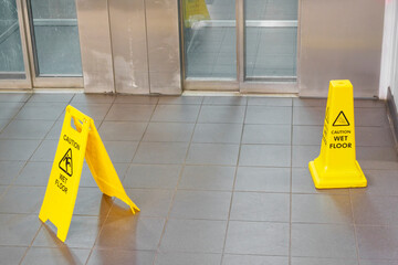 Caution wet floor cone safety notice at public stair