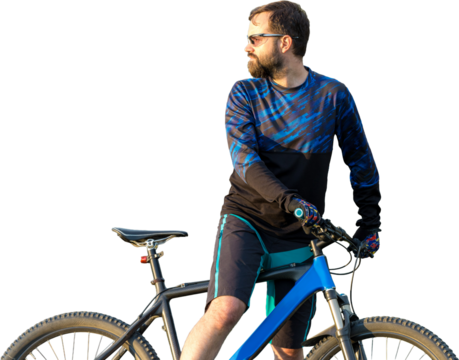 Cyclist in pants and fleece jacket on a modern carbon hardtail bike with an air suspension fork rides off-road. The guy is resting on a stump in the park, looks into the distance.