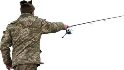 Fishing in the reeds for spinning on quiet water. A man in camouflage clothes in cool weather is fishing on the river bank.