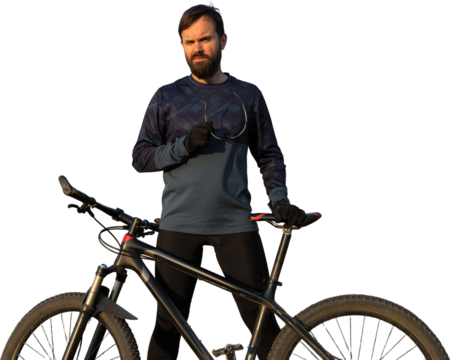 Cyclist in shorts and jersey on a modern carbon hardtail bike with an air suspension fork standing on a cliff against the background of fresh green spring forest