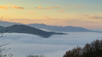 the valley between the hills in the fog	