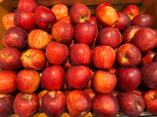 Fresh organic red apples at a market. Bunch of apples are displayed on the table for sale