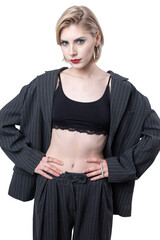 Portrait of a seductive, stylish business lady in the studio. Blonde girl in a suit and top.