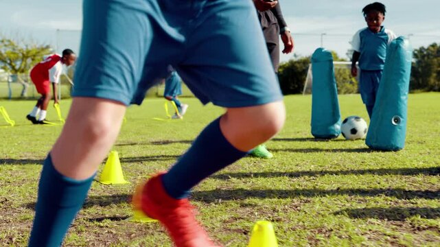 Soccer, players and dribble with ball on grass field for sport practice, training or fitness on pitch. Children, legs and running with football, obstacles or cones for skill, technique or control