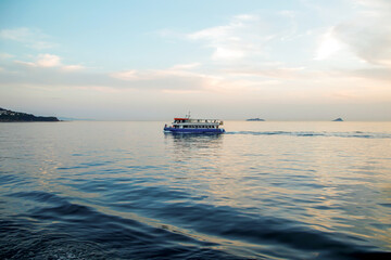 Passenger boat in the sunset sea in istanbul