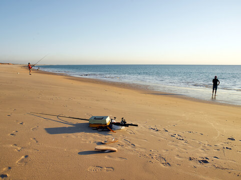 Fishing gear and fisherman on a remote beach