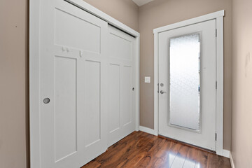 White door with a glass window and a wooden floor