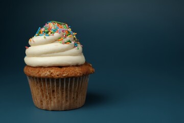 Sprinkled cupcake with creamy white frosting
