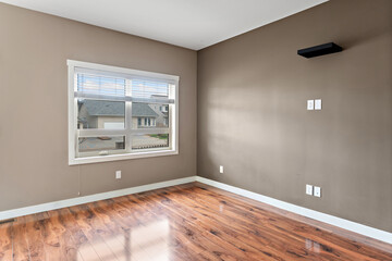Large room with a window and a wall