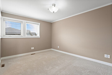 Room with a white wall and a tan carpet