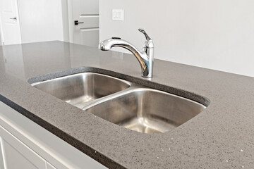 Sink with a silver faucet sits on a countertop