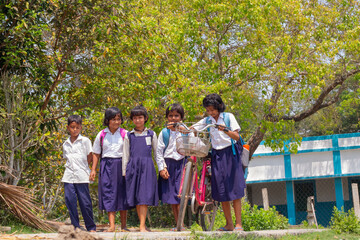 Indian school Childrens share a joyful moment With bicycle on a sunny day