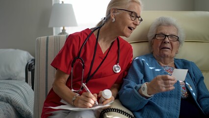 A caregiver interacts with an elderly woman, providing attentive care and support in a well-lit healthcare facility, fostering engagement and connection.