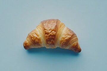 Single croissant on simple pastel backdrop
