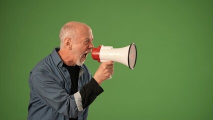 A mature man stands confidently, using a megaphone to make an announcement. His expression displays...