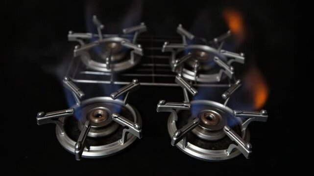 Four Propane Butane Gas Burners and Metal Grid on Black Background