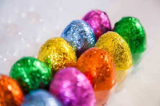 Colourful, foil wrapped Easter eggs in rows