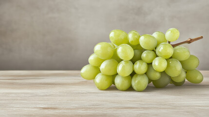 Fresh green grapes glistening on wooden surface, showcasing their natural beauty and freshness