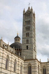 Siena Cathedral (Duomo di Siena) lateral view with the bell tower, Italy.
