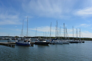 Beautiful bright nature of the coast of the Gulf of Finland with bright white yachts, boats, fishing boats in Espoo city, Finland.