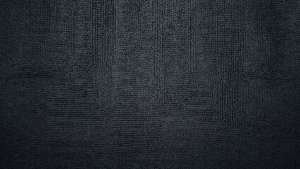 Close-up view of a monochrome grey carpet texture from above.