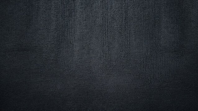 Close-up view of a monochrome grey carpet texture from above.