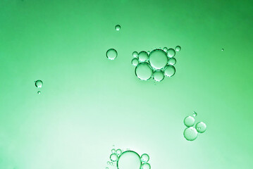 oil with bubbles on green background. Abstract space background. Soft selective focus. macro of oil drops on water surface. copy space. air bubbles in water