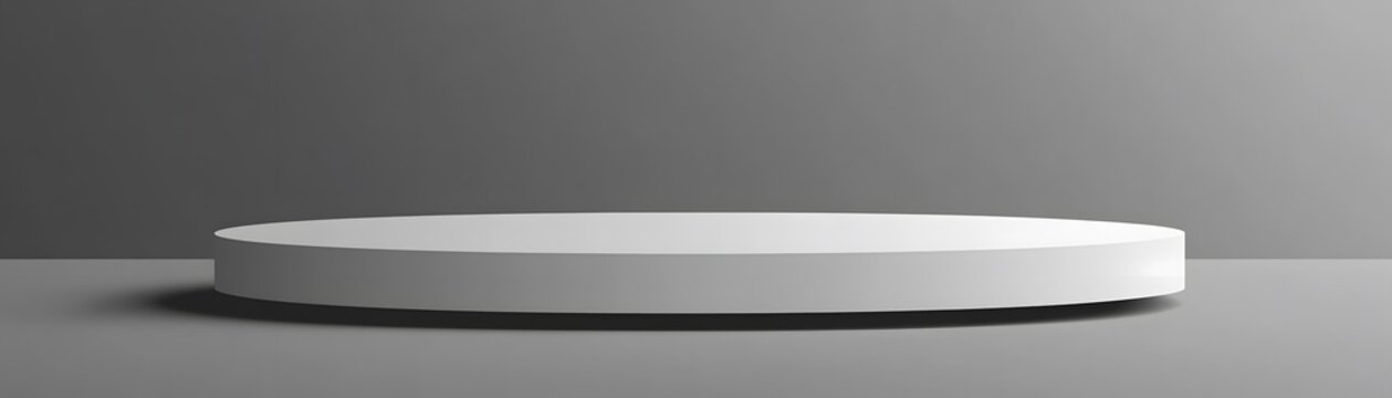 Empty, round, white display podium on a gray surface.