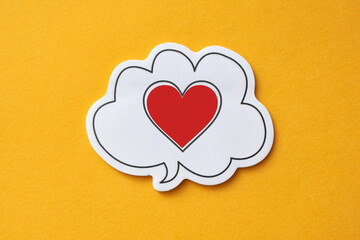 Red paper heart on a balloon with a speech. A symbol of love, messages of love and declarations of...