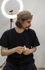 Tattoo artist creating a custom design for a young woman in a cozy Tbilisi studio. Details of the...