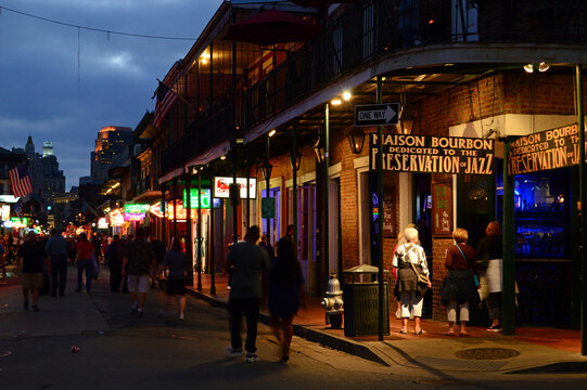 The lights of the French Quarter in New Orleans begins to illuminate the taverns, cafes and restaurants at night, 